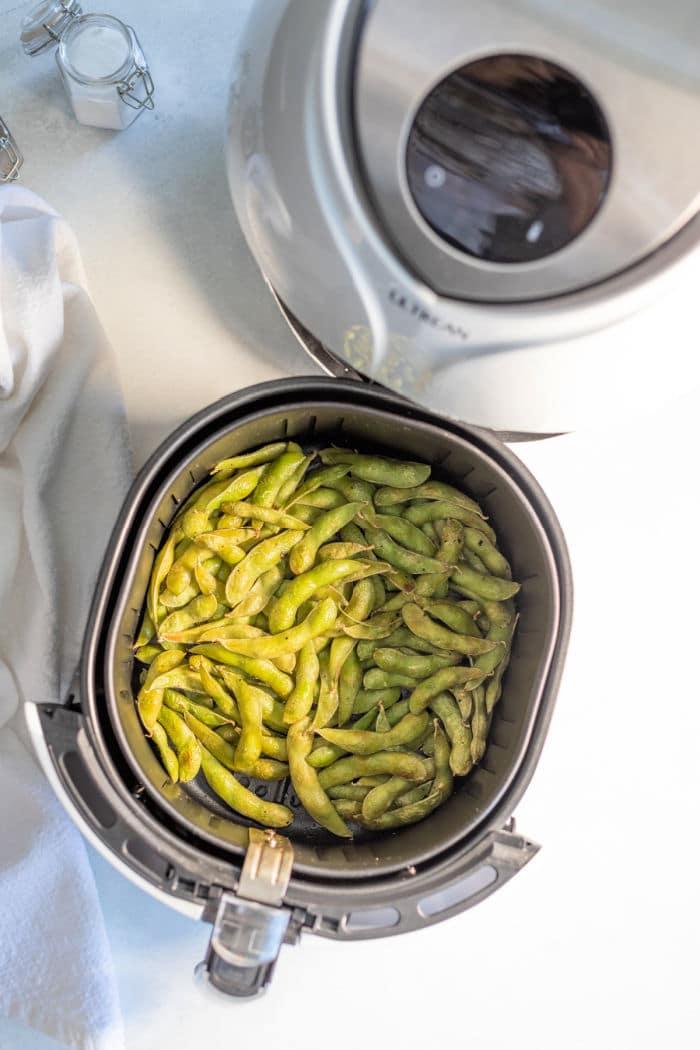 An air fryer is the perfect tool for effortlessly cooking edamame beans to perfection. The basket is filled with tender, green delights, offering a healthy and delicious treat thats quick and easy to prepare.