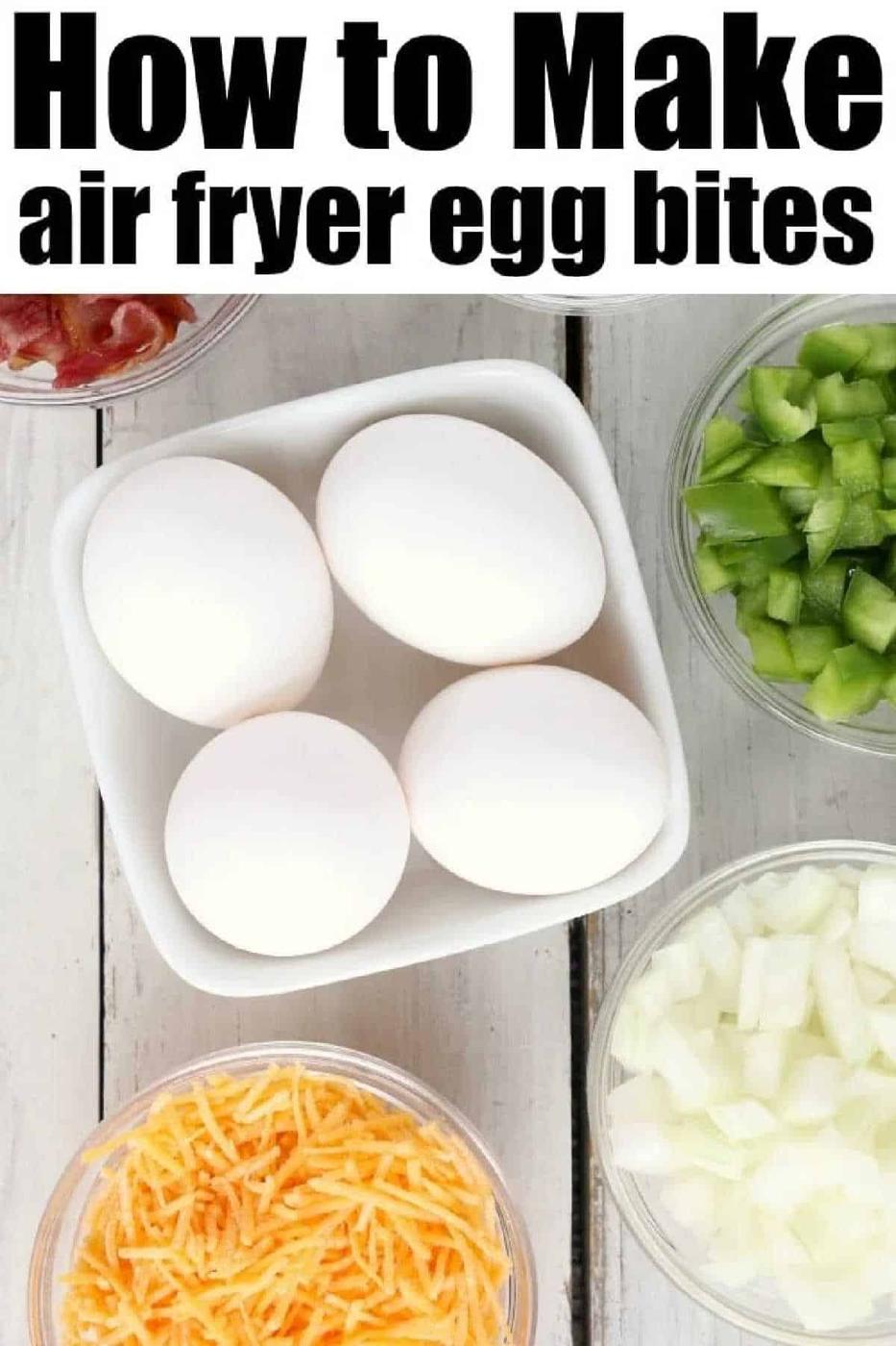 Four eggs in a bowl surrounded by chopped green pepper, onions, shredded cheese, and bacon—with air fryer egg bites recipe text above.