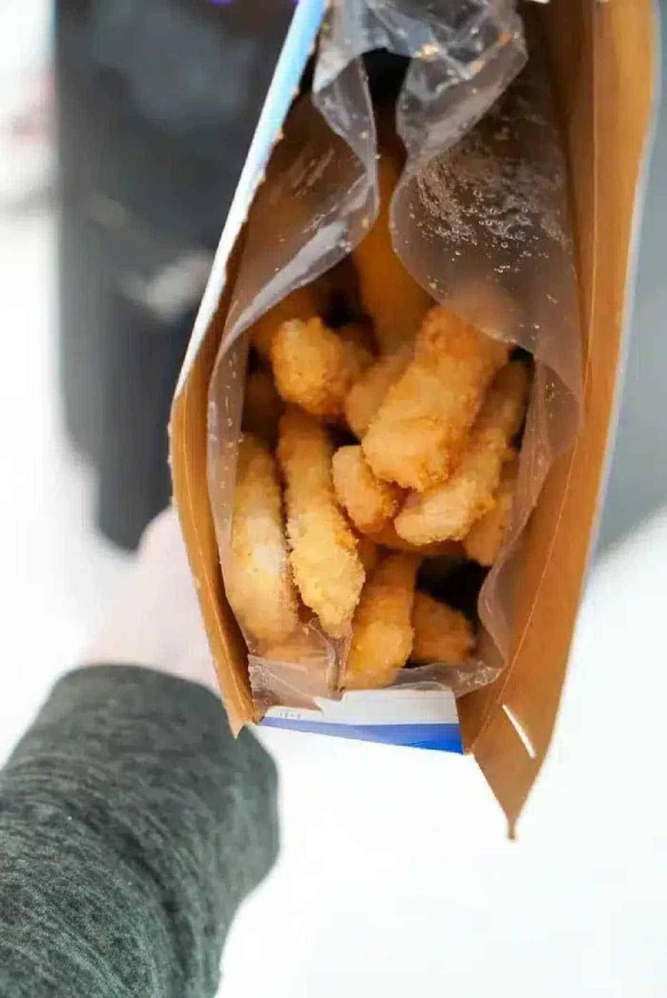 Open box of frozen breaded fish sticks viewed from above, perfect for making crispy air fryer fish sticks at home.
