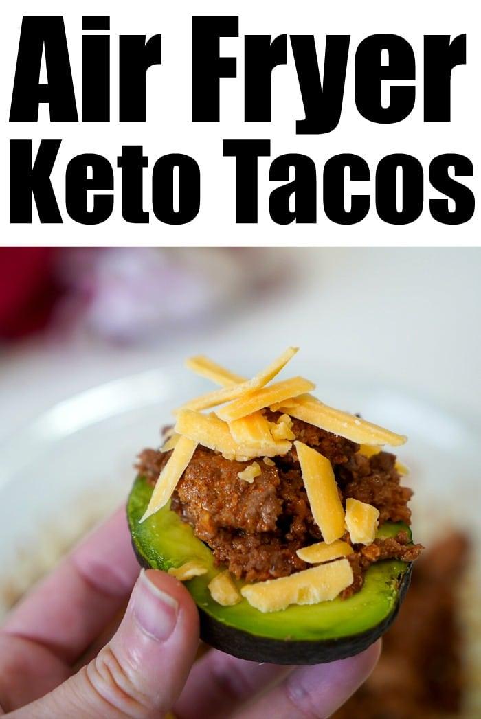 Close-up of a hand holding a taco in a zucchini shell, perfectly cooked with air fryer ground beef and topped with shredded cheese.