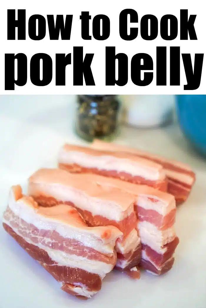 Image of three thick slices of raw pork belly on a white surface with text at the top that reads "How to Cook Air Fryer Pork Belly" in bold black letters. In the background, there is a blurry, partially visible pepper grinder and other kitchen items.