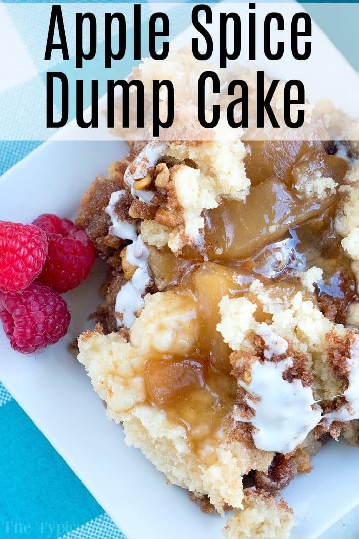 Close-up of apple spice dump cake on a plate with raspberries, showcasing its crumbly texture, visible apple filling, and a delicate drizzle of glaze.