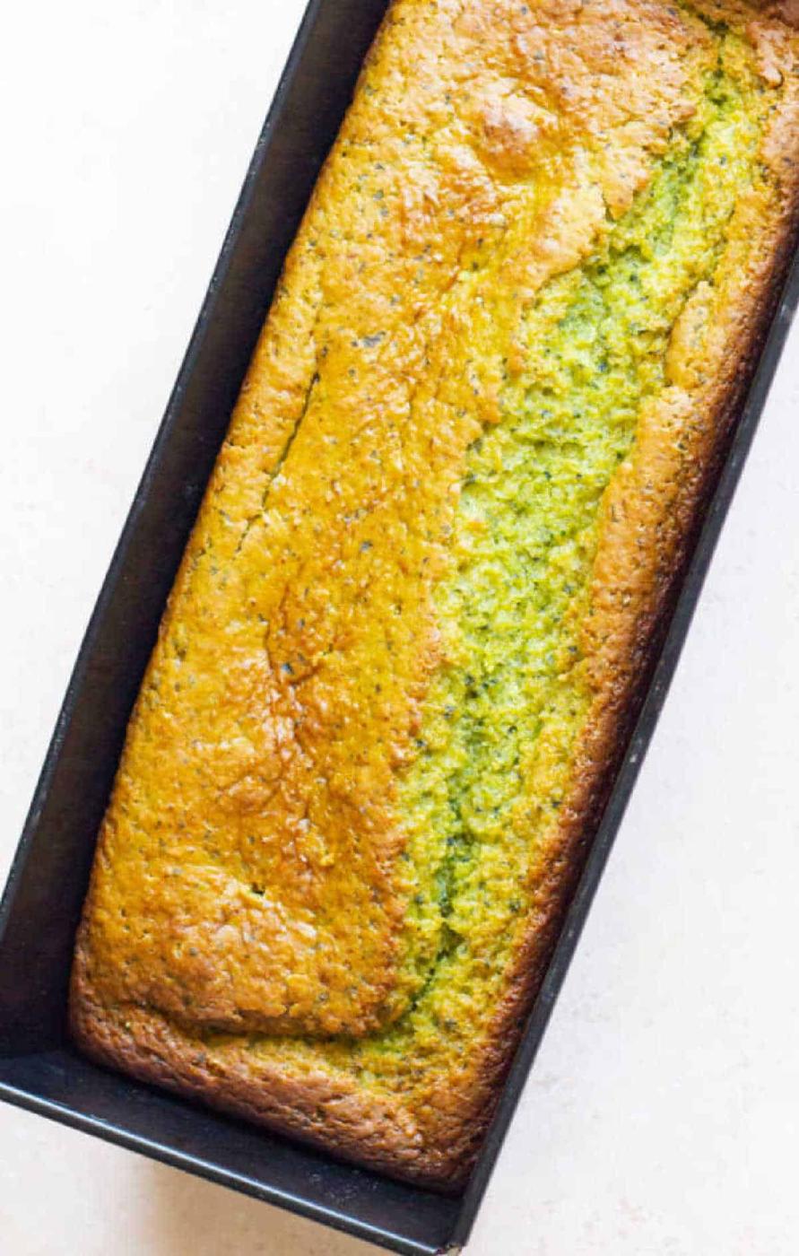 A loaf of homemade avocado bread shares the spotlight with its new cousin, avocado cake, in a rectangular baking pan.