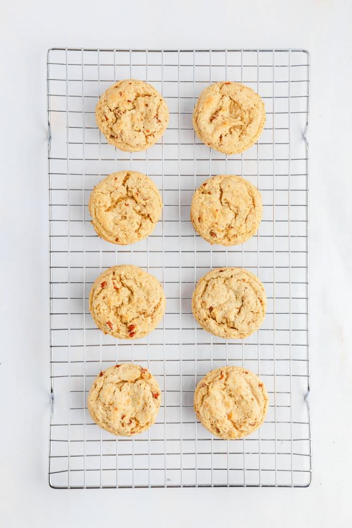 Eight butter pecan Cookies cooling on a wire rack, arranged in two neat columns on a white background.