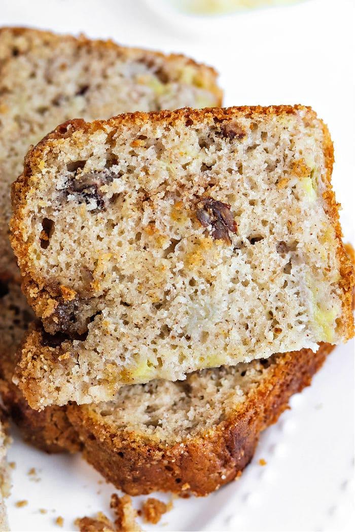 Close-up of slices of bisquick banana bread with walnuts on a white plate