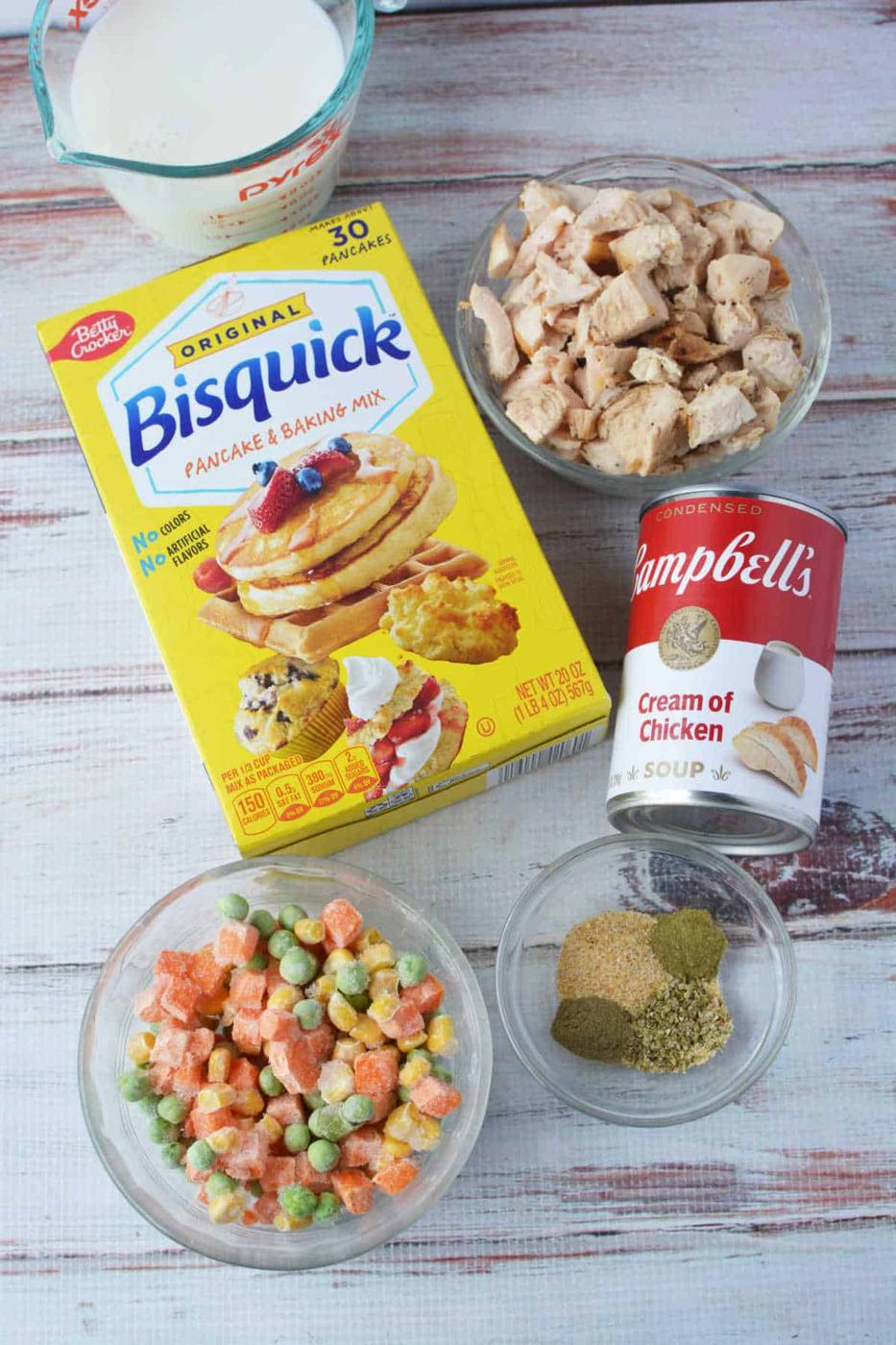 Bisquick chicken and dumplings made easy—just combine Bisquick, milk, cooked chicken, cream of chicken soup, frozen veggies, and seasonings for a comforting classic on a wooden table.