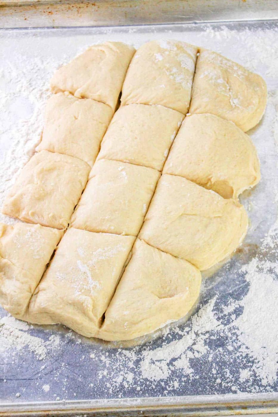 Divided dough pieces on a floured surface, ready for baking, perfect for crafting your favorite Bunny Bread recipe.
