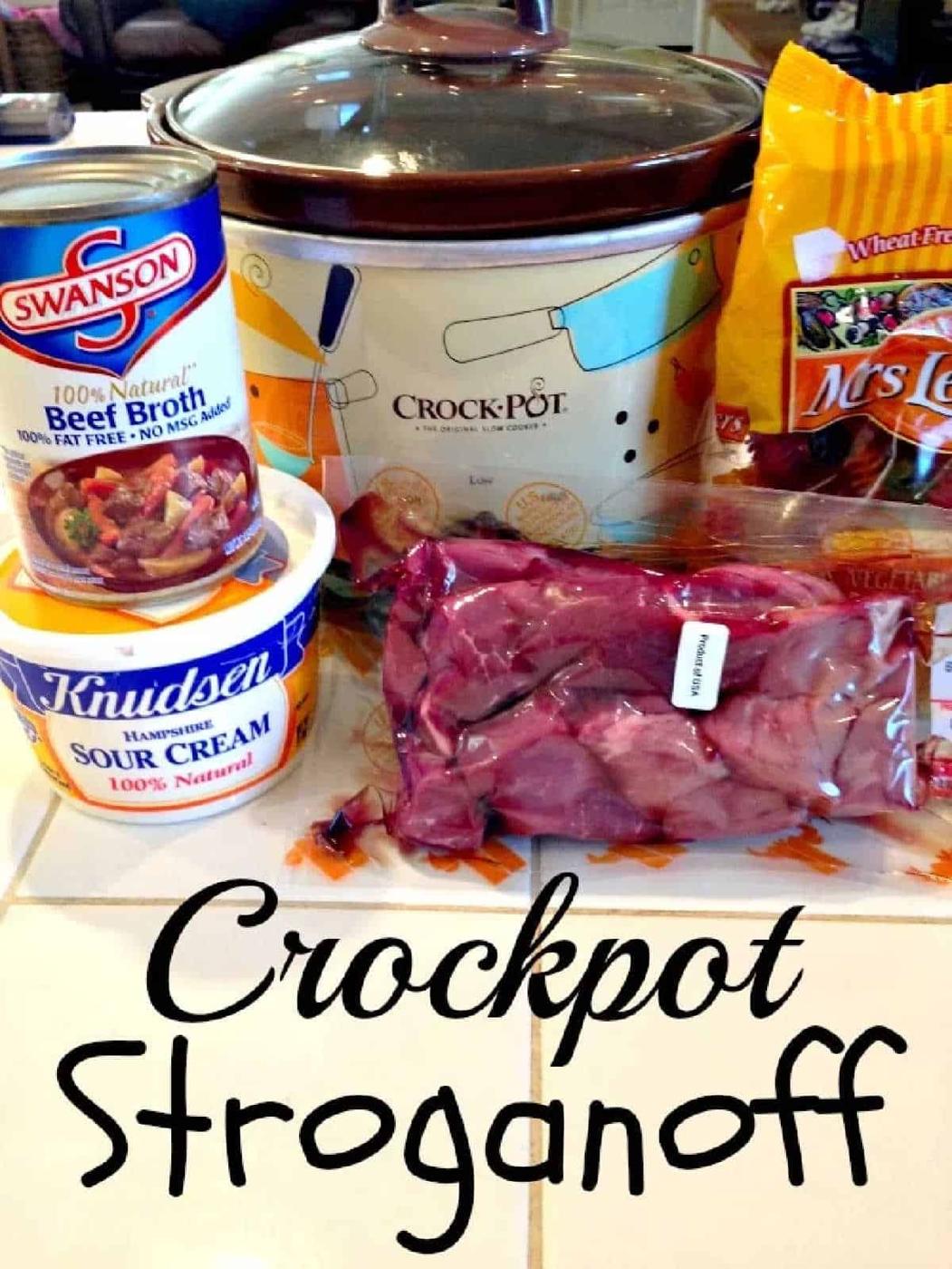 Crockpot beef stroganoff ingredients—beef broth, sour cream, noodles, and tender beef—arranged on a counter and ready for your next cozy meal.