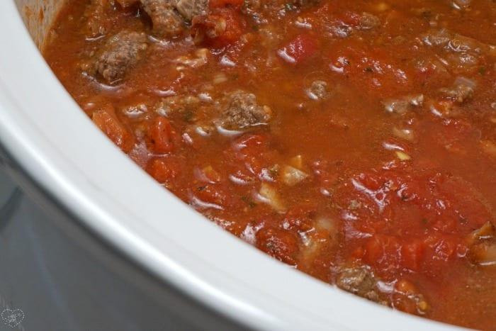 A hearty classic hamburger helper recipe cooks in a slow cooker for dinner.