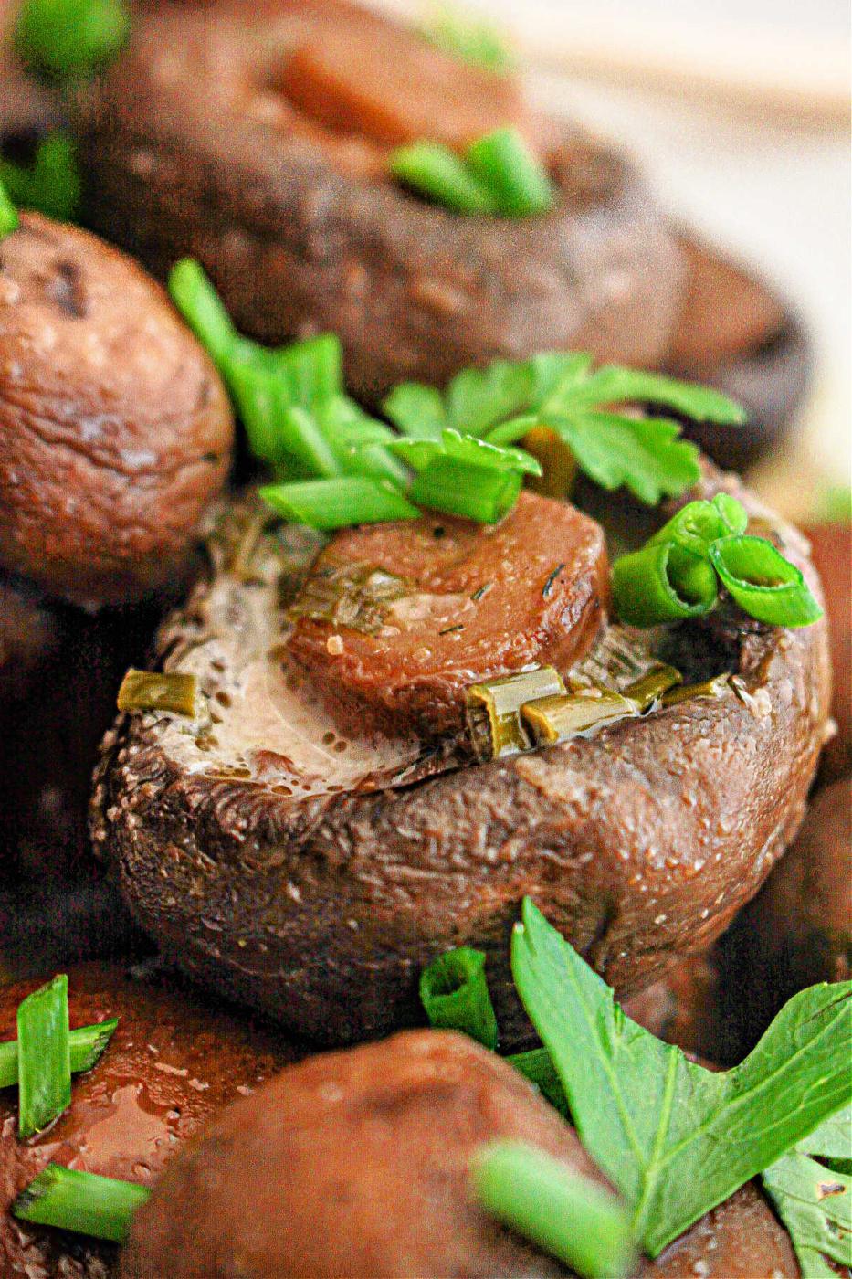 Crockpot mushrooms topped with herbs and a slice of sausage deliver a savory delight.