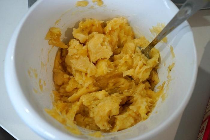 A white bowl holds delectable mashed banana