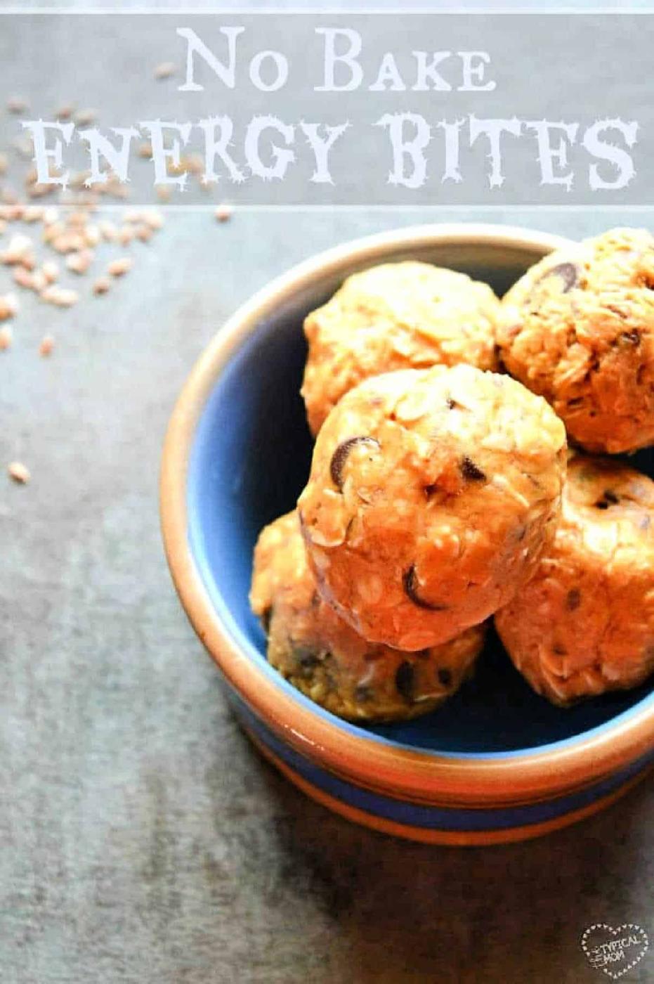 A blue bowl filled with no-bake energy bites sits on a gray surface, with text above reading No Bake Energy Bites—a simple and delicious energy ball recipe perfect for quick snacks.