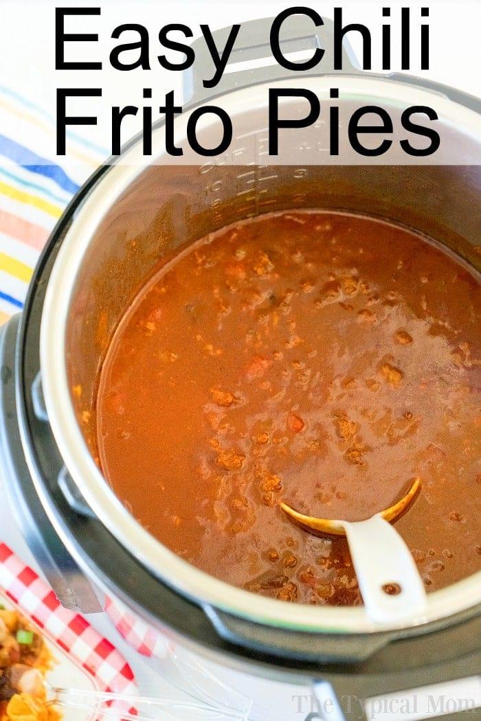 Instant Pot filled with delicious chili, titled "Easy Chili Frito Pies," showcases the perfect Instant Pot Frito Chili Pie recipe, complete with a serving spoon inside.