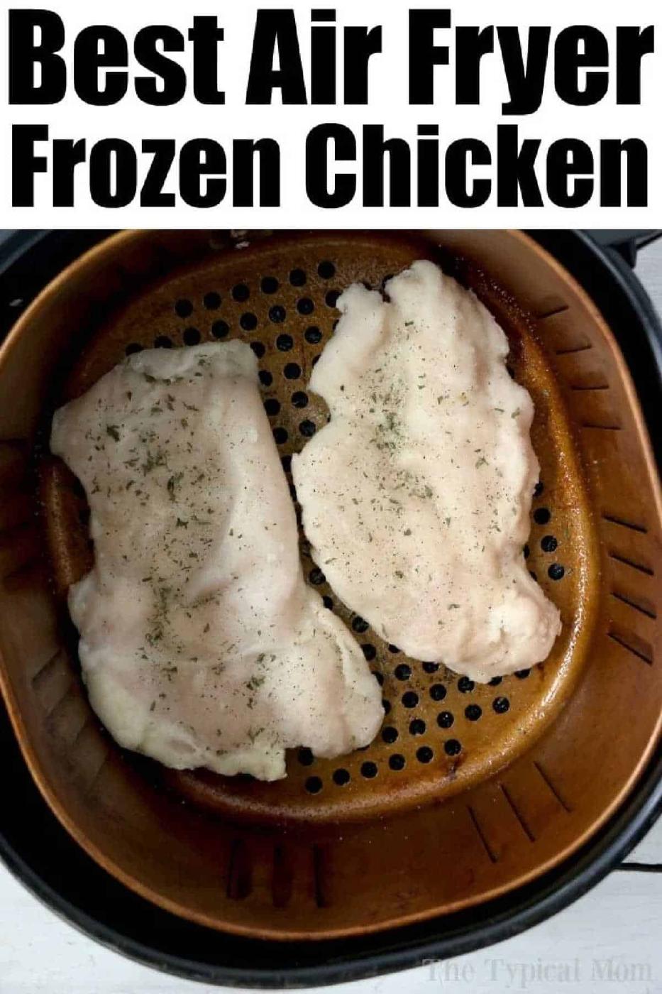 Two raw, seasoned chicken breasts—or even a frozen chicken breast—sit in an air fryer basket, ready to be cooked.