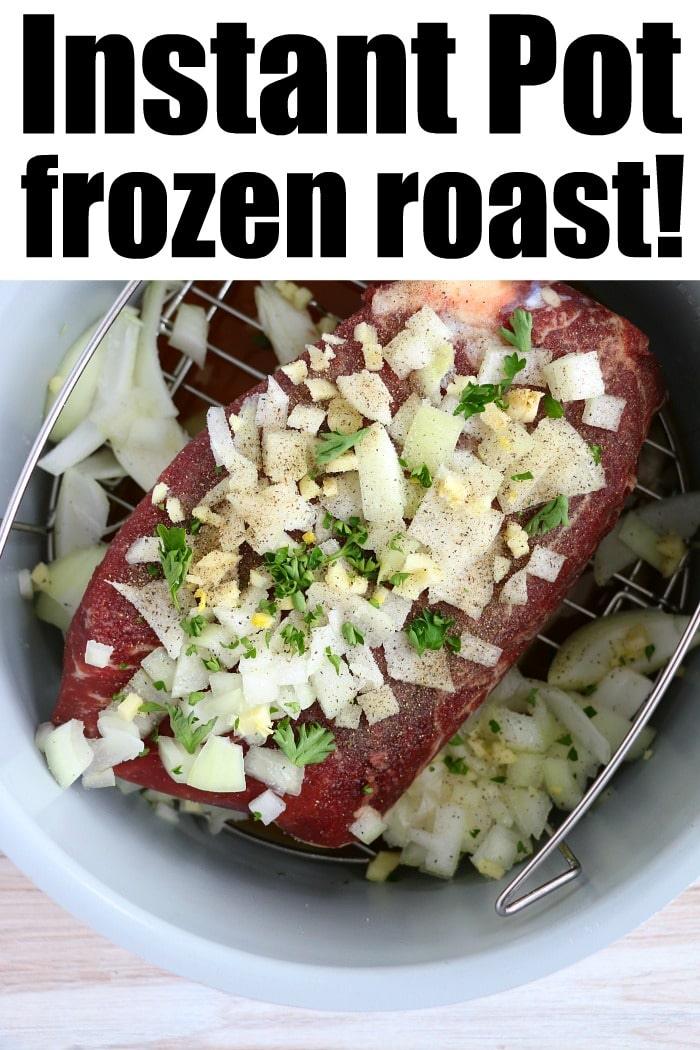A raw frozen roast covered with chopped onions, garlic, and herbs sits inside an Instant Pot on a metal trivet. The caption reads "Frozen roast in Instant Pot magic!