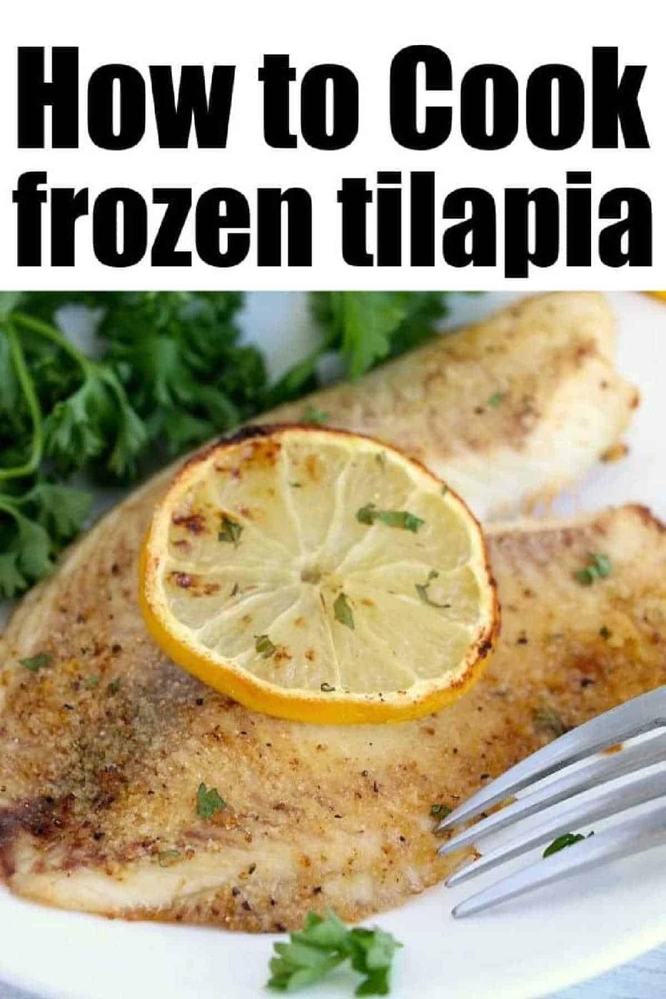 Cooked tilapia, fresh from the air fryer, with a lemon slice and parsley garnish sits enticingly on a white plate, alongside a gleaming fork.