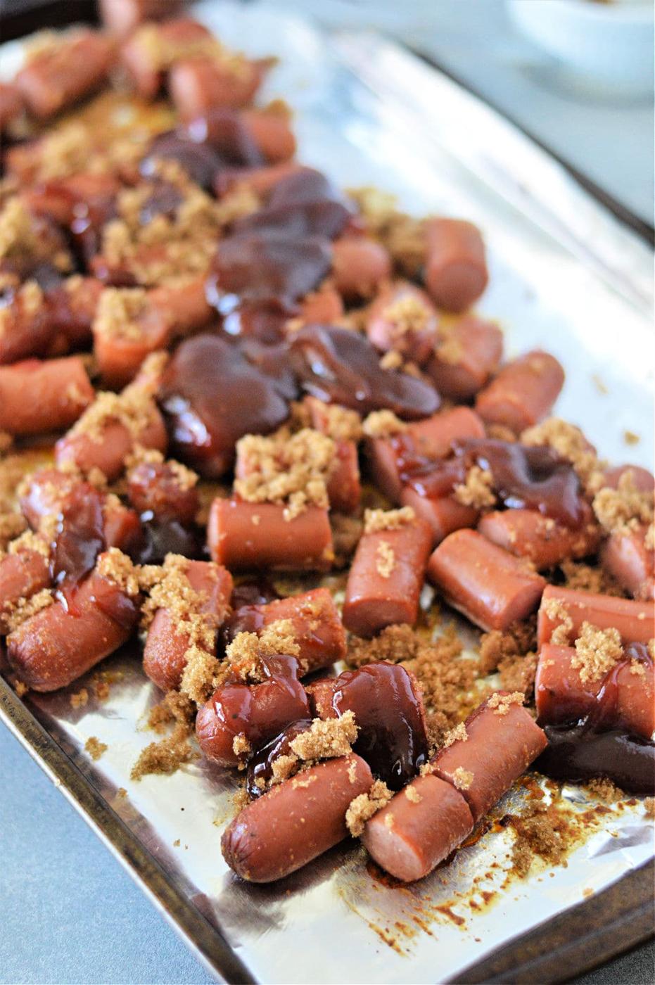 Savor the irresistible taste of Hot Dog Burnt Ends, crafted from chopped hot dogs glazed with brown sugar and barbecue sauce, all roasted to perfection on a baking sheet.