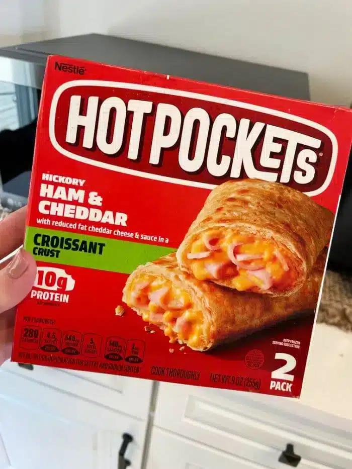 A person holding a box of Nestlé Hot Pockets wonders,