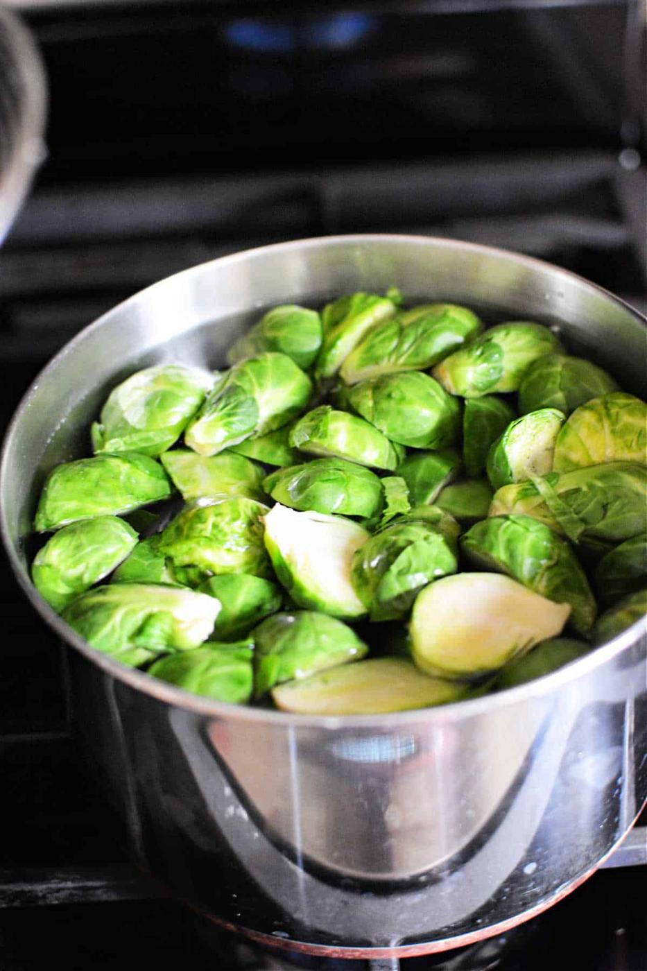 Brussels sprouts simmer gently in a stainless steel pot on the stovetop, filling the kitchen with their earthy aroma. Wondering how long to boil Brussels sprouts for perfect tenderness? Aim for about 8-10 minutes.