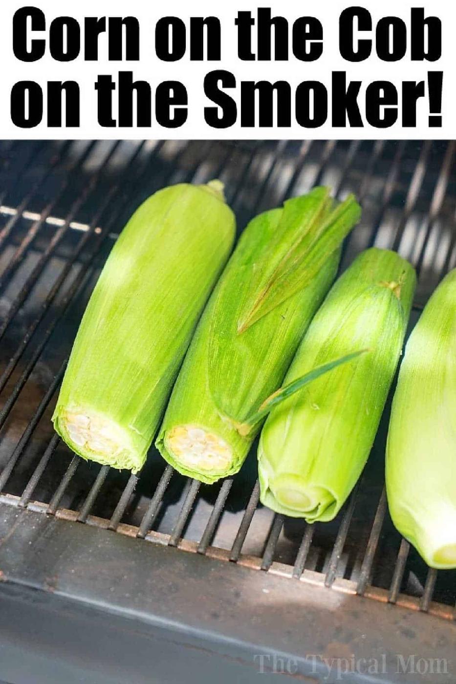 Three ears of corn in husks are placed on a smoker grill with text above that reads Corn on the Cob on the Smoker—showing how to smoke corn on the cob for delicious, smoky flavor!.