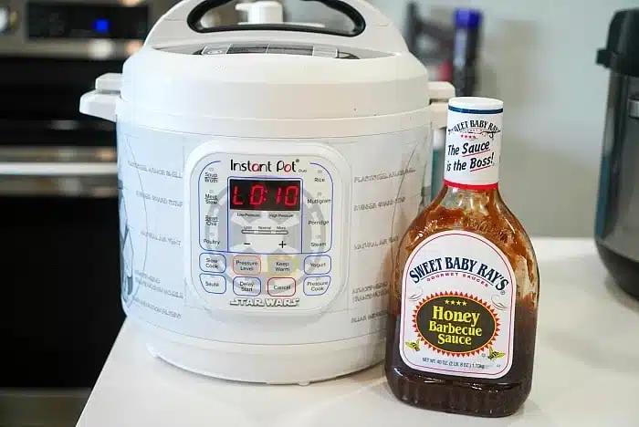 A Star Wars-themed Instant Pot sits on the kitchen counter alongside a bottle of Sweet Baby Ray's Honey Barbecue Sauce—perfect for whipping up delicious instant pot BBQ beef.