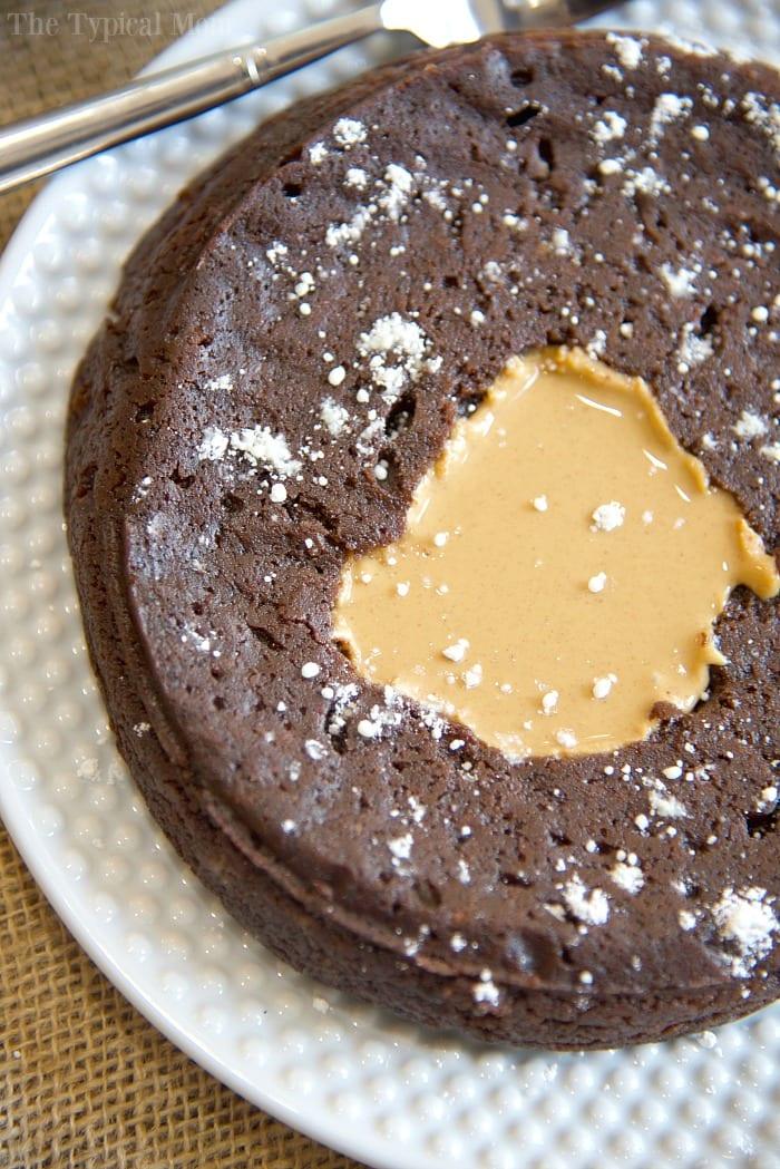A brownie with a gooey peanut butter center, elegantly served on a white plate.