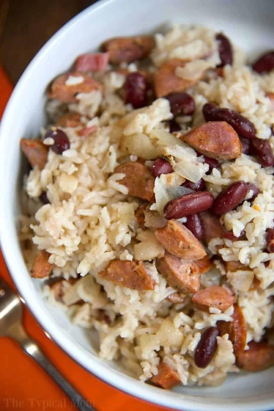 A bowl of rice mixed with kidney beans, chopped sausage, and onions—just like a classic instant pot red beans and rice recipe.