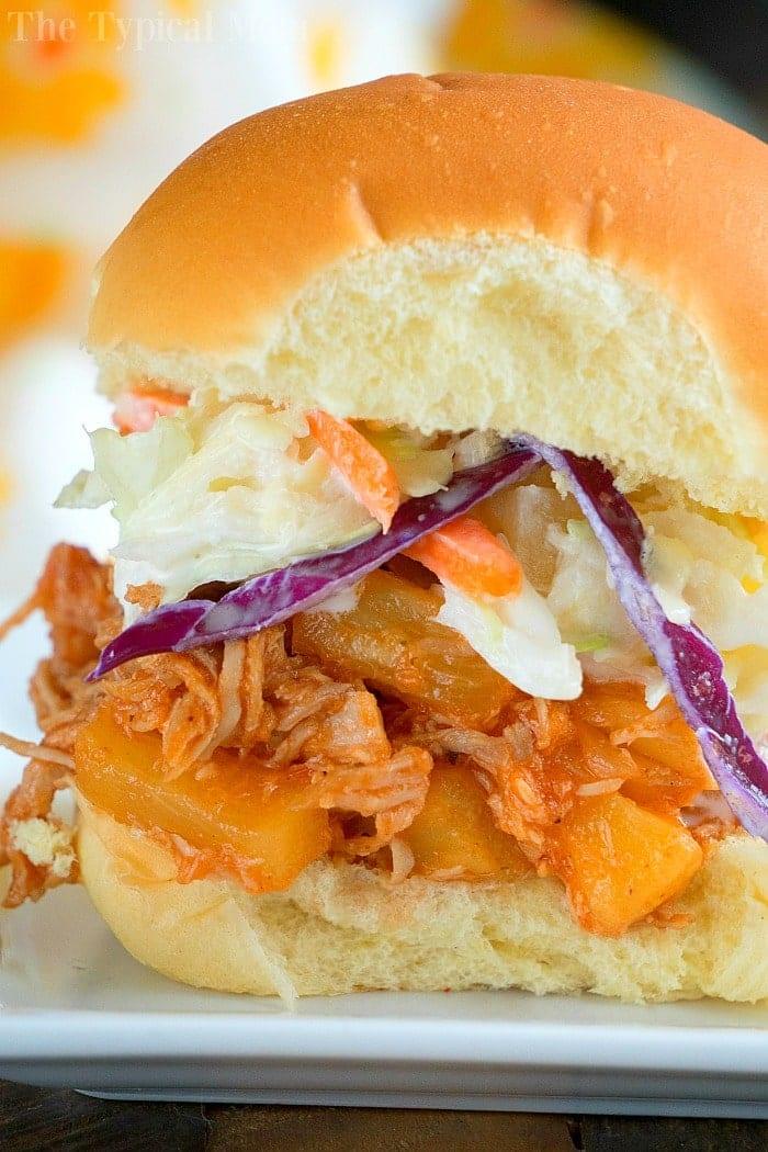 A delightful pulled pork sandwich with coleslaw and pineapple, perfect for your July gatherings, crafted effortlessly with Instant Pot magic.