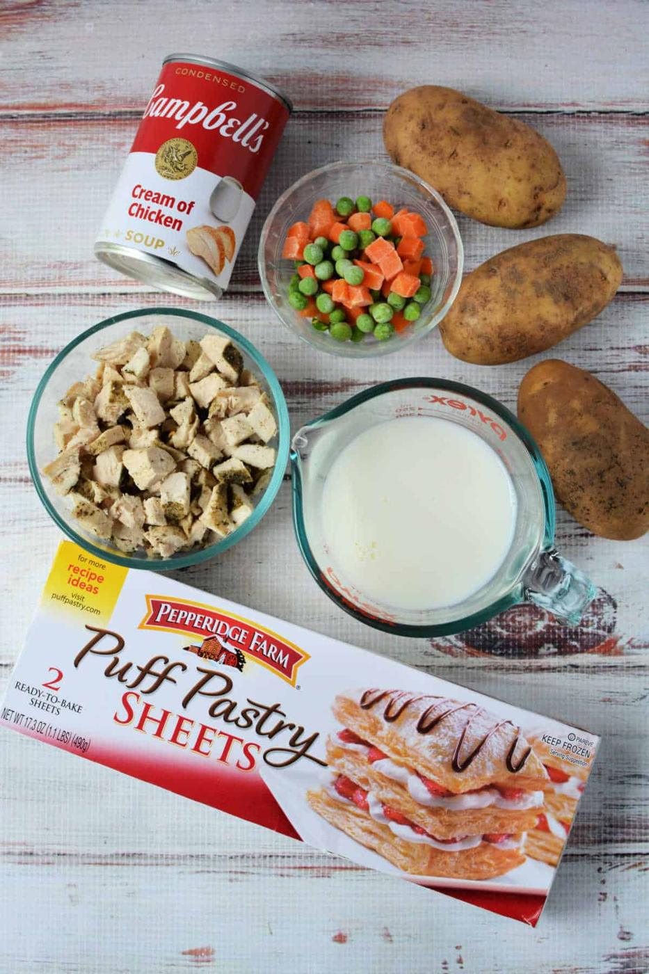 Ingredients for a delicious Chicken Pot Pie Recipe: potatoes, mixed veggies, milk, cream of chicken soup, cooked chicken, and puff pastry sheets—just like the classic KFC Chicken Pot Pie!.
