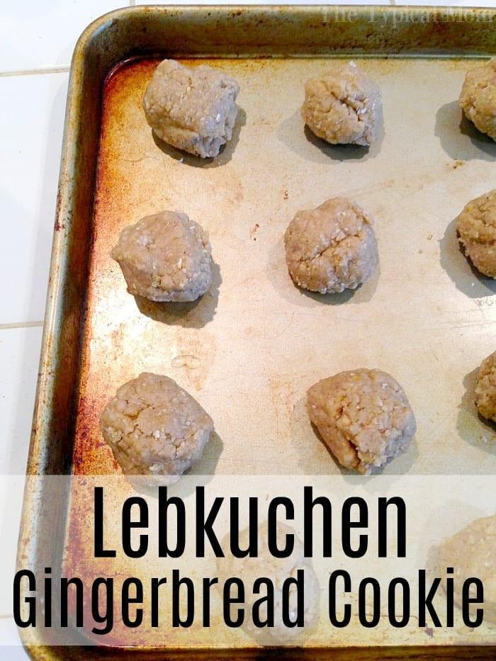 Unbaked Lebkuchen cookies rest on a metal baking sheet, labeled Gingerbread Cookie.