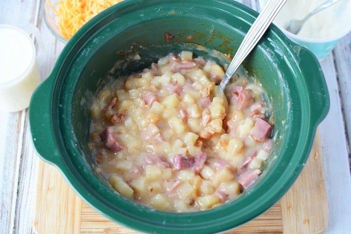 This totally loaded baked potato soup in the crockpot is super easy recipe to make and so delicious! You only need a few ingredients and it only costs about $10 to feed up to 6 people. Stovetop and pressure cooker potato soup instructions included too so you can cook it any way you want. #potato #soup #loaded #crockpot #slowcooker #pressurecooker #cheese 2
