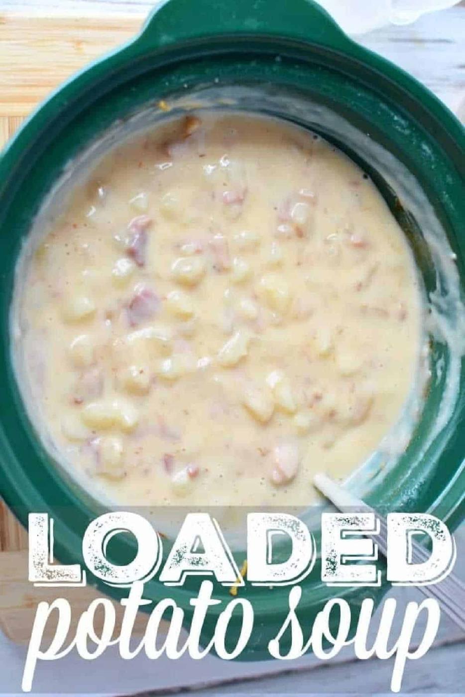 A crockpot filled with creamy Crockpot loaded baked potato soup, featuring chunks of potatoes and ham, and text LOADED potato soup.