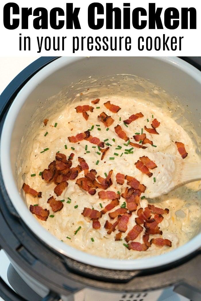 Close-up of a Ninja Foodi pressure cooker filled with creamy chicken topped with crispy bacon bits and chopped chives. The text reads Crack Chicken made easy. A wooden spoon rests in the mixture, ready to serve a delicious meal.