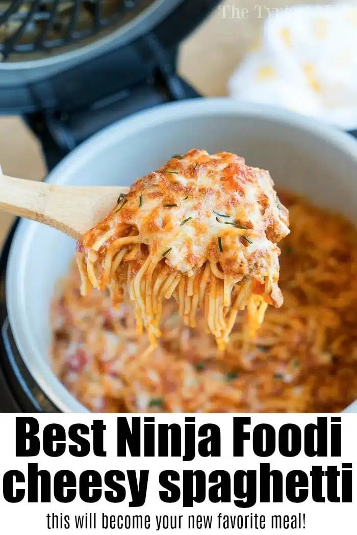A wooden spoon lifts cheesy spaghetti from a pot, with melted cheese and sauce visible—a delicious example of ninja pressure cooker recipes.