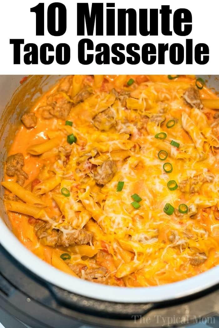 A taco casserole with ground meat, melted cheese, pasta, and sliced green onions, cooked to perfection in a Ninja Foodi. Text at the top reads, "10 Minute Taco Casserole.