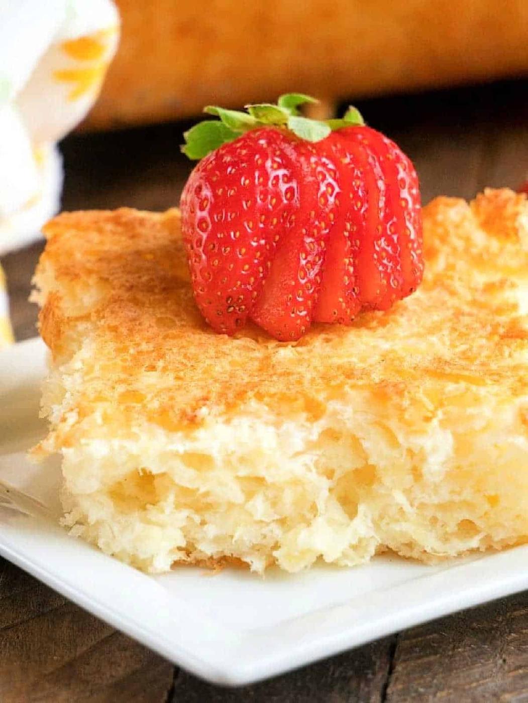 A slice of fluffy, golden pineapple angel food cake recipe.