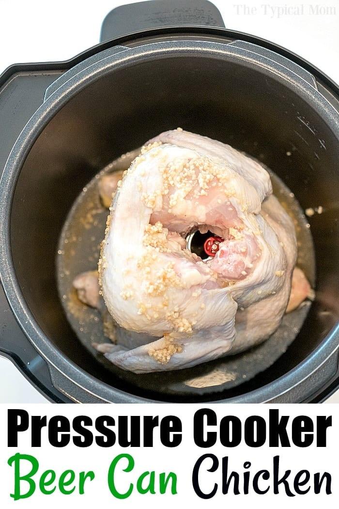 A raw chicken perched on a beer can inside a pressure cooker, ready for cooking.