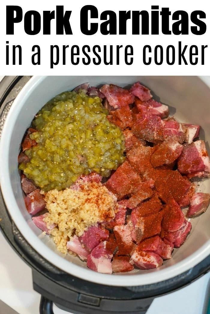 An overhead view reveals a pressure cooker brimming with raw pork chunks, vibrant green chilies, minced garlic, and bold red spices, all set for crafting delicious pressure cooker carnitas. The text above declares, "Pork Carnitas in a Pressure Cooker.