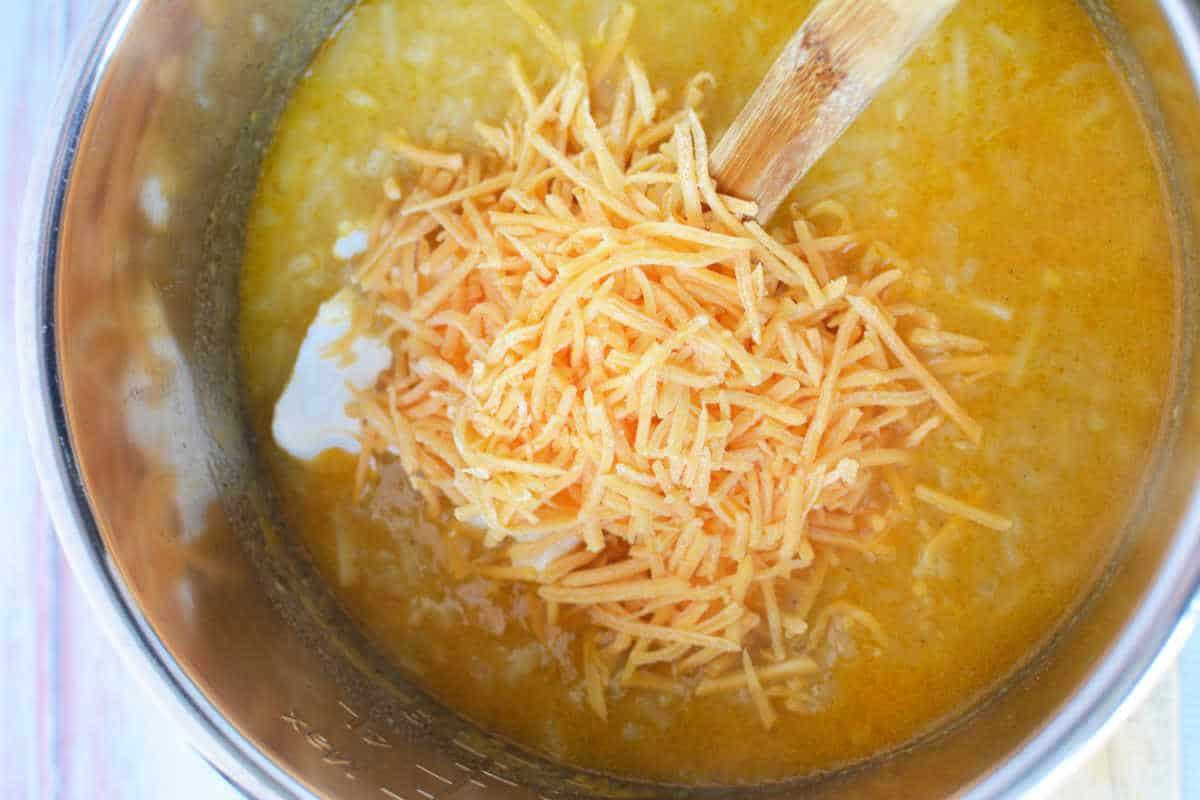 Shredded cheese melts into a creamy yellow soup, bubbling gently in the pot as a wooden spoon stirs. This Pressure Cooker Potato Soup is made even heartier with the addition of Frozen Hash Browns for a comfort meal thats both quick and delicious.