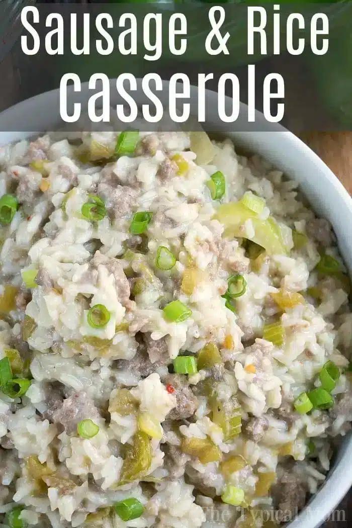 A close-up of an Instant Pot sausage and rice casserole in a white bowl. The dish is garnished with chopped green onions, showcasing a savory mixture of rice, sausage, and green peppers. The image features text reading "Sausage & Rice Casserole.