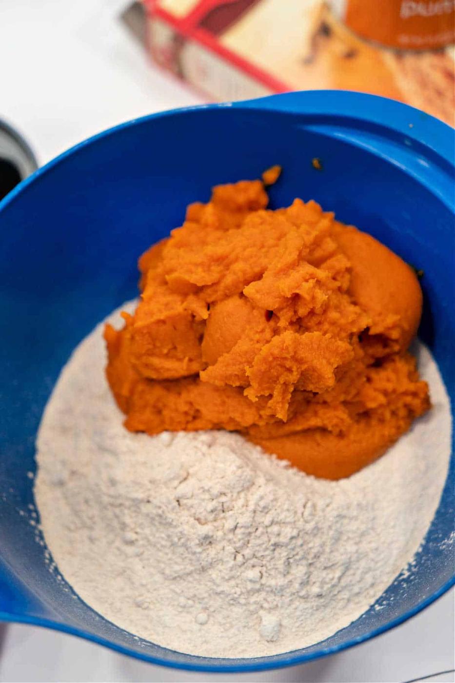 The blue bowl holds a delightful blend of cake mix and pumpkin puree, the perfect base for crafting a batch of pumpkin bread with spice cake mix.