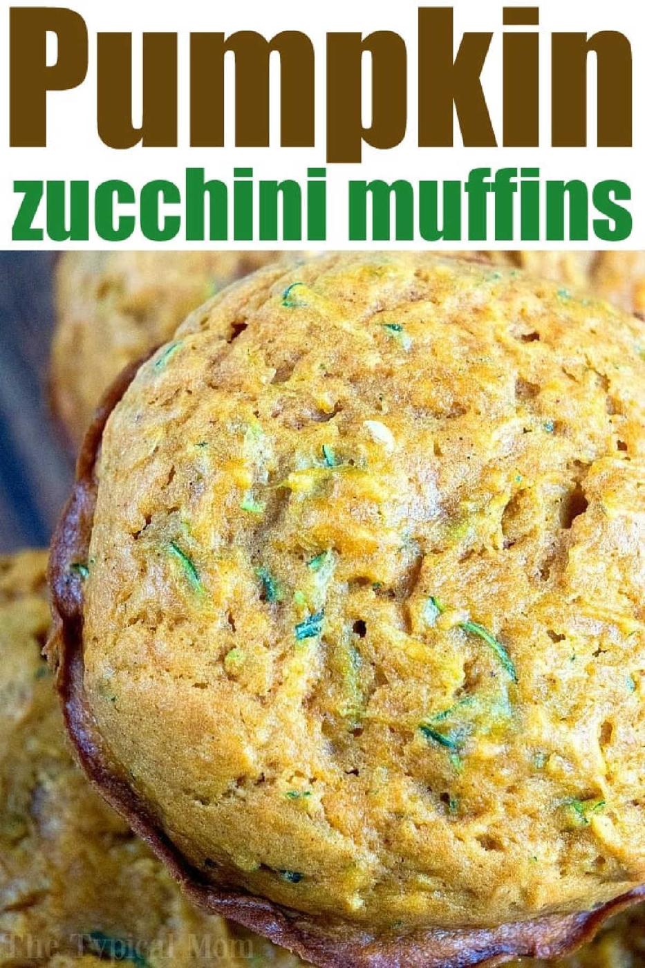 Close-up of pumpkin zucchini muffins with visible green zucchini shreds, surrounded by more muffins.