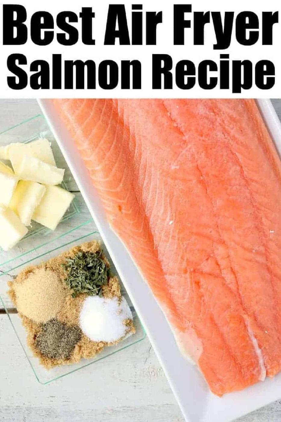Raw salmon fillet with small dishes of butter and various seasonings on a light surface, perfect for preparing salmon in the air fryer.