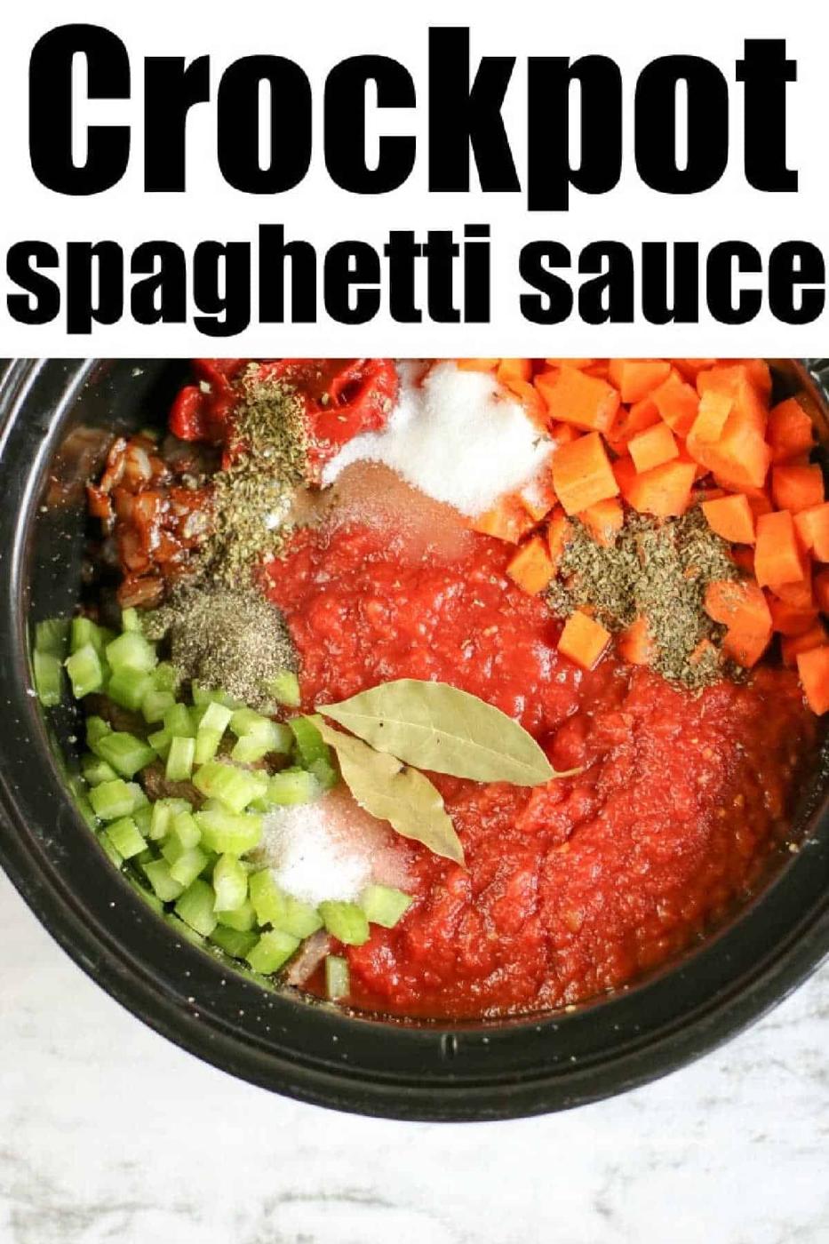 Crockpot filled with tomatoes, carrots, celery, seasonings, bay leaves, and leftover beef for a hearty slow cooker spaghetti sauce.