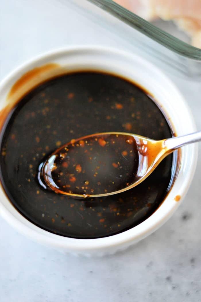 A white bowl filled with dark homemade teriyaki sauce