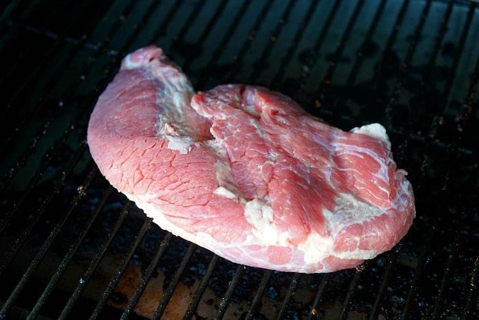 A juicy corned beef brisket sizzles on the grill, ready to transform into a delicious masterpiece.