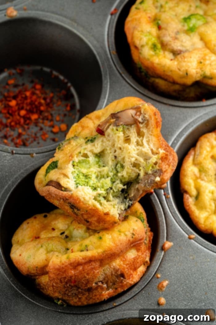 Broccoli & Cheddar Egg Bake 7 Individual low-carb quiche muffins on a plate, showcasing their perfectly baked appearance.