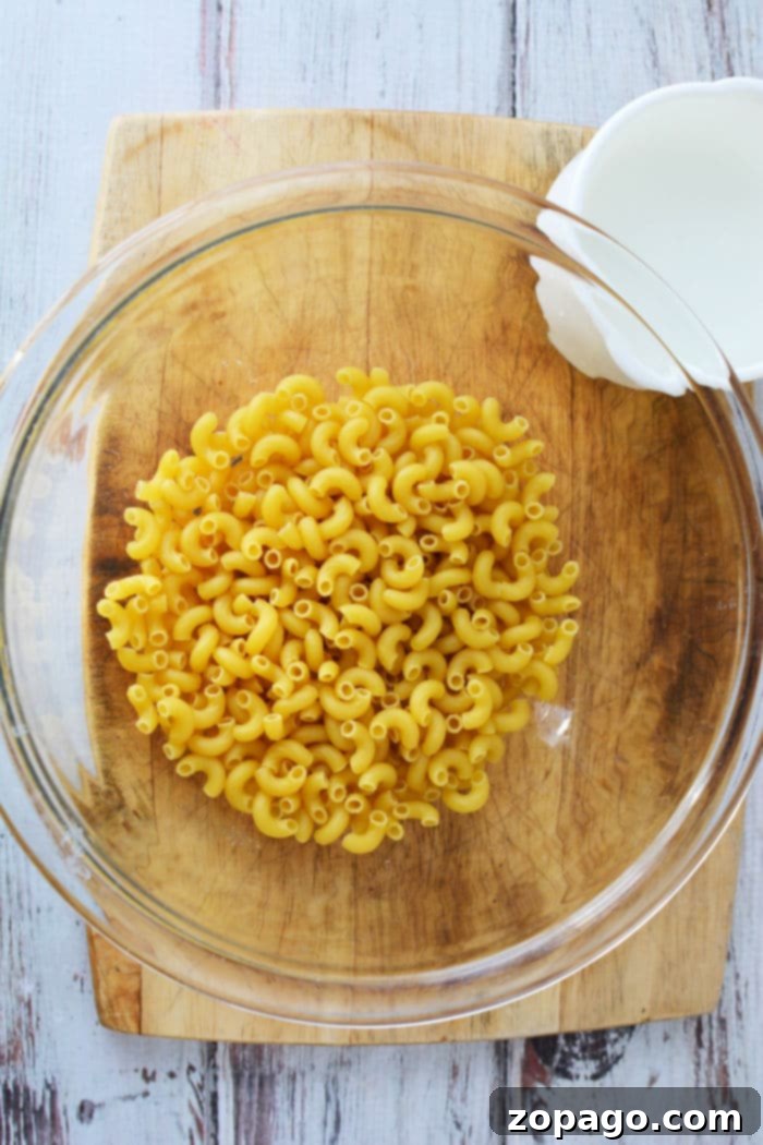 Effortless Microwave Pasta 4 Cook Pasta in the Microwave, showing a covered bowl inside a microwave.