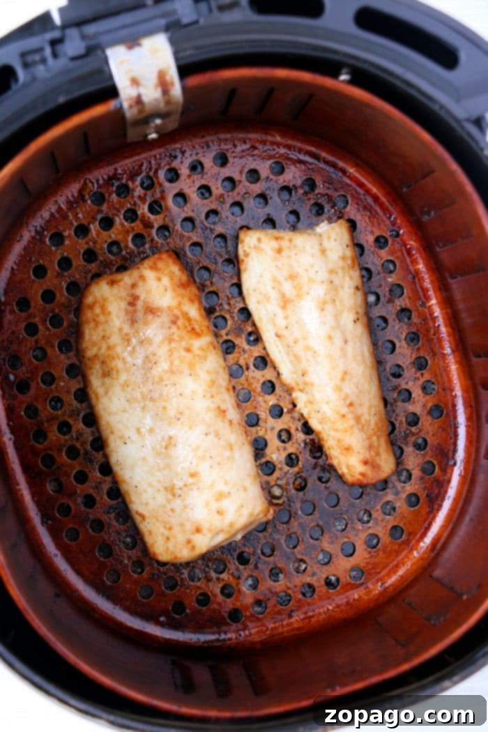 Wholesome Air Fryer Creations 9 Delicate white fish fillets in an air fryer basket