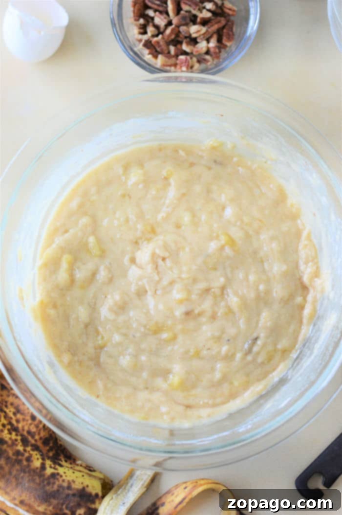 Banana Muffin Minis 6 Preparing banana muffin batter in a bowl